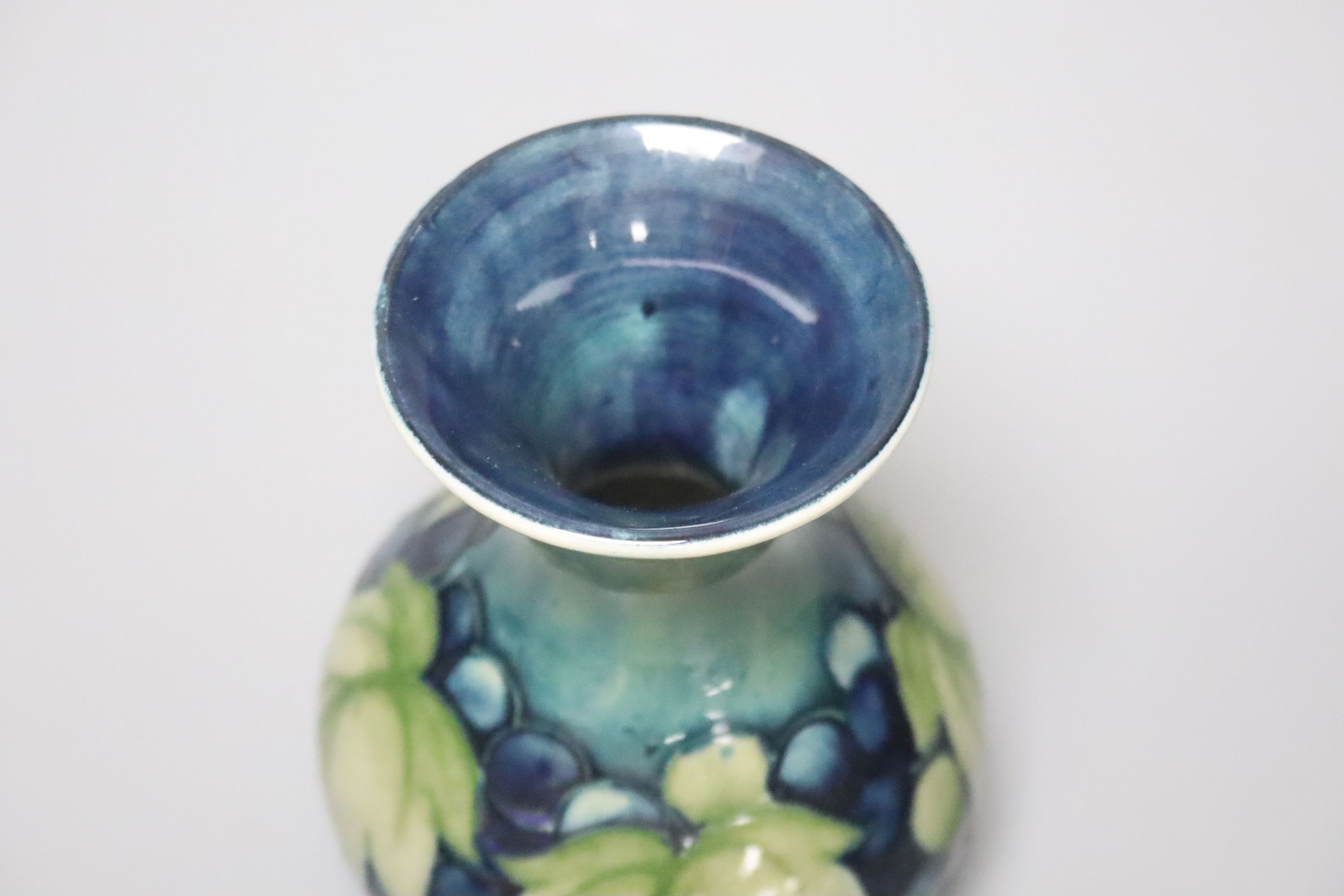 A Moorcroft green and blue leaf and berry vase, height 13cm